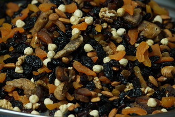 Mixed dried fruits and nuts close up. Mix of dried fruits, nuts and berries. Organic food texture.