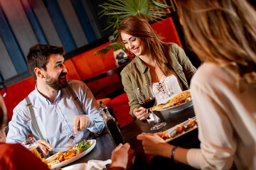 Young people having dinner in the restaurant