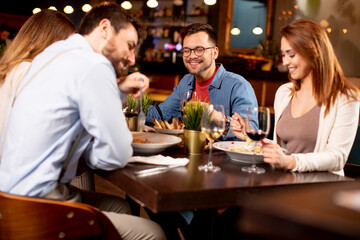 Young people having dinner in the restaurant