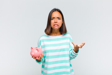 young hispanic woman looking angry, annoyed and frustrated screaming wtf or what’s wrong with you