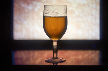 White wine in glass on glass surface