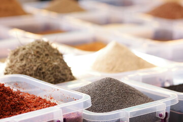 Spices for sale at market. Chia seeds in plastic box on display at market. Healthy organic food.