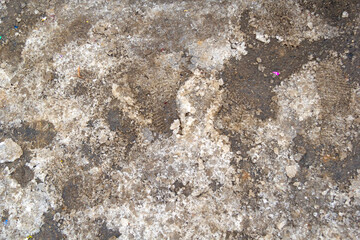 dirty snow with footprints from the shoes. Close. visible in places asphalt and candy from the flap