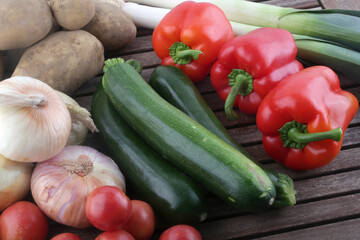 red paprika leeks zucchini potatoes tomatoes and onions as fresh vegetables group