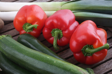 red paprika leeks zucchini potatoes tomatoes and onions as fresh vegetables group