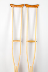 Wooden crutch on a white isolated background. Medical equipment