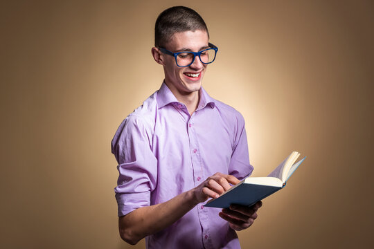 Handsome Single Male Reading Book And Feeling Really Happy, Studio Photo