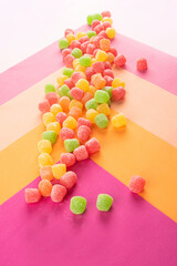 Gummy candy, arrangement of gummy candy thrown on a colored surface.