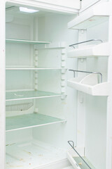 Fototapeta na wymiar Dirty empty open fridge. Condition before cleaning inside.