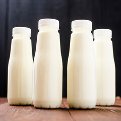 Bottles with milk, yogurt on a wooden background. Natural dairy products.