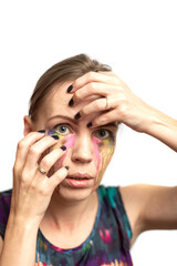 Woman with different colors of tears on a white background. Creative make-up.