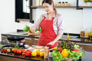 Asian beautiful woman cooking organic meal fish in kitchen 