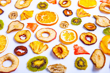 Fototapeta na wymiar Organic Healthy Assorted Dried Fruit Mix close up. Dried fruit snacks. dried apples, mango, feijoa, dried apricots, prunes top view