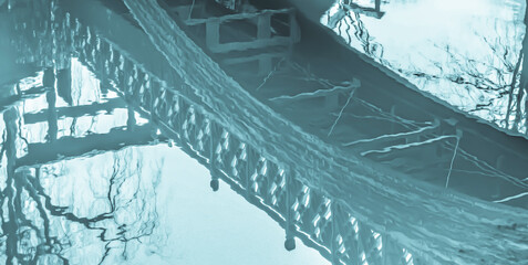 Reflecting waters of a foot bridge