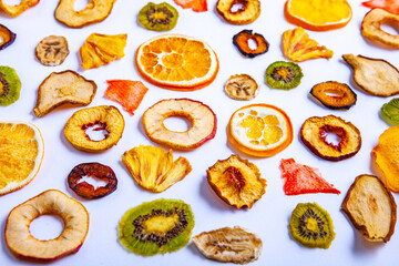 Fototapeta na wymiar Organic Healthy Assorted Dried Fruit Mix close up. Dried fruit snacks. dried apples, mango, feijoa, dried apricots, prunes top view