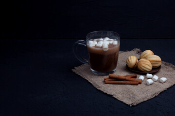 delicious walnut shaped shortbread sandwich cookies filled with sweet condensed milk and chopped nuts and a mug of cacao and mini marshmallows