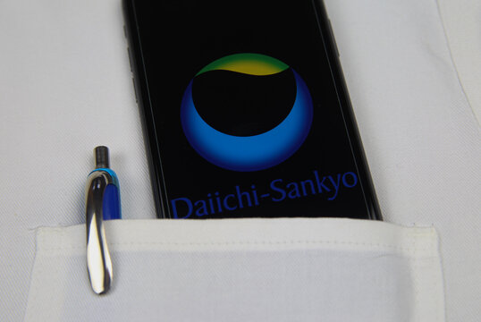 Viersen, Germany - April 9. 2020: Close Up Of Mobile Phone Screen With Logo Lettering Of Daiichi Sankyo Health Pharmaceutical Company In Pocket Of White Doctors Coat With Pencil