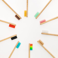 Multicolored bamboo toothbrushes on white background