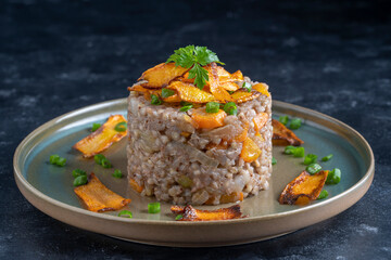 Boiled buckwheat with fried carrots and onions, close up