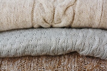 Grey beige and brown sweaters close up