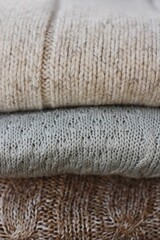 Grey beige and brown sweaters close up