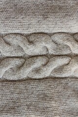 Beautiful beige knitted sweater close up view 