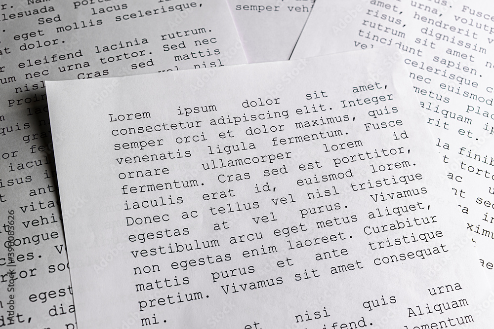 Fototapete lorem ipsum dolor sit amet concept. selective focus photo of paper sheets with publishing and graphi