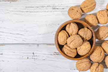Walnuts kernels on white wooden desk, stock photo