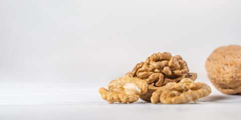 Fototapeta na wymiar Walnuts kernels on white wooden desk, stock photo
