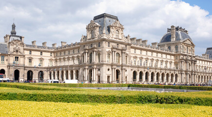  Place Carrousel, Louvre. Tourists walk and take pictures. Transport moves with tourists