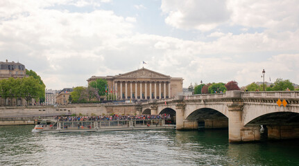 View of the National Assembly. Under the bridge floats ship with tourists on board
