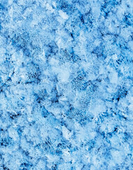 Winter or Christmas vertical background with snow patterns, crystals close-up and snowflakes. Natural snow frosty background with copy space, frozen, abstract, wallpaper, texture surface