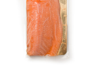 Fillet of red fish in vacuum packing lies on a white background. Isolate. View from above. Place for text.