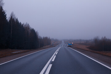 road in fog concept, mist in october halloween landscape, highway