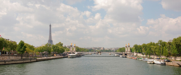  View of the Alexander lll Bridge . By the embankments are moving cars and pedestrians