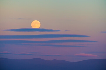 Rising Harvest Moon over Casade Mountain Range