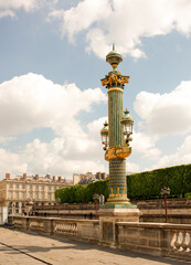 Rostral column with lanterns on the Place de la Concorde. By area moving pedestrians