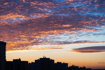 sky, colorful bright crimson dawn sunrise over the city, beautiful view of the dawn sky, orange yellow blue sky color