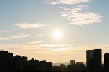 Fototapeta na wymiar orange yellow sunrise sun rays sun over the city, new day, Wallpaper, blue sky, cloud
