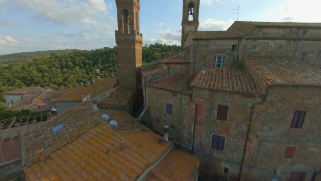 Sky View Of Comune Sinalunga In Tuscany Italy With Historical Buildings Surrounded By Lush Green Mountains Under The Bright Cloudy Sky - Aerial Shot