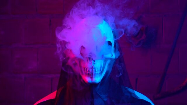White smoke comes out in slow motion from someone wearing a scary skeleton mask. scary footage for hiphop videos