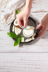Diet and health nutrition, vegetarian concept. Alternative nut milk from coconut on a wooden table. Top view flat lay background. Copy space.