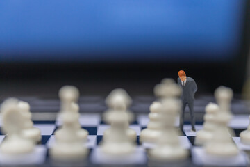 Business Planning Concept. Closeup of businessman miniature figure people standing on chessboard with chess pieces