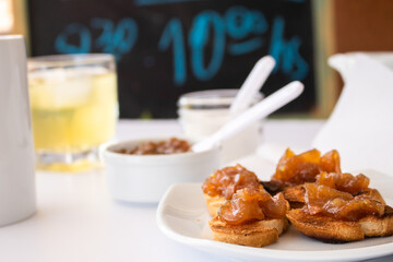 Homemade bread toast with a delicious homemade apple and onion chutney, with cinnamon on a light white board. Perfect jam for breakfast. Breakfast, cooking, food concept.