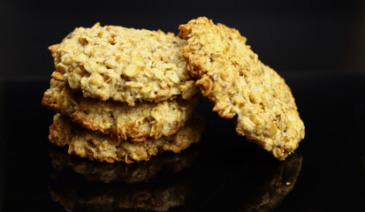 sweet homemade oatmeal cookies on a mirrored black table