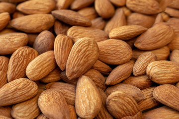 A lot of almonds nuts close-up. Natural background for healthy eating concept