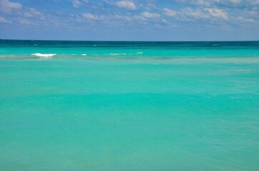 Turquoise caribbean sea on Varadero coast in Cuba, blue sky with clouds background, copy space