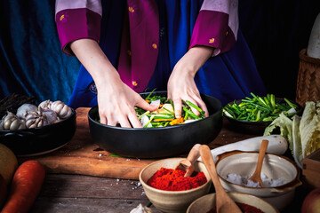 Close up images of Hand of Korean woman, she making Kimchi which is a fermented food preservation of Korean people consisting of many fresh vegetables and fruits