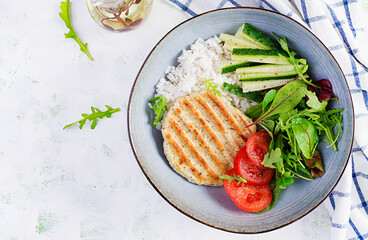 Chicken schnitzel or cutlet, poultry meat grilled and boiled white rice with fresh salad. Healthy...