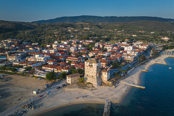 Aerial drone view of iconic medieval seaside town of Ouranoupolis featuring famous tower,...